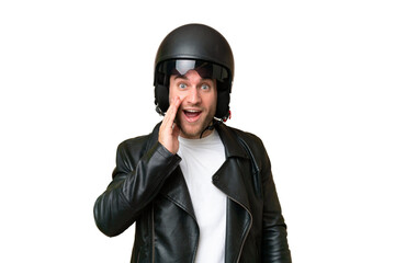 Young caucasian man with a motorcycle helmet isolated on green chroma background with surprise and shocked facial expression
