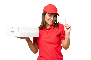 Pizza delivery caucasian woman with work uniform picking up pizza boxes isolated on green chroma background showing and lifting a finger in sign of the best