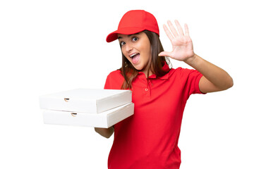 Pizza delivery caucasian woman with work uniform picking up pizza boxes isolated on green chroma background counting five with fingers