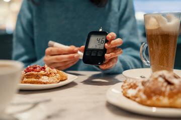 Diabetic woman measuring normal sugar level. Preparing yourself for meals
