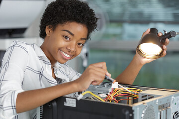 happy young woman holding pc wire