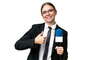 Young TV presenter caucasian woman  over isolated background with thumbs up because something good has happened