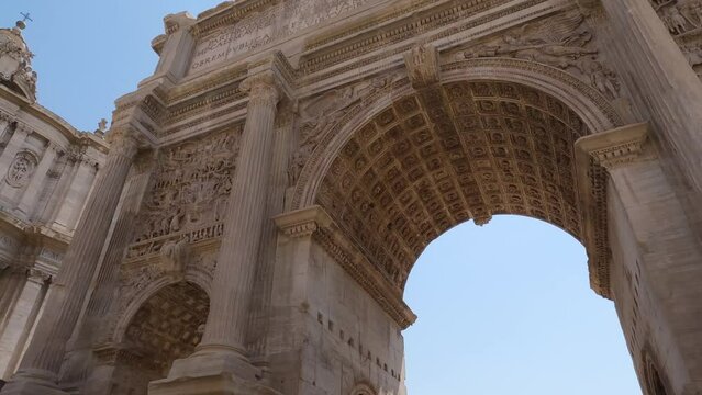 Tilt down from Septimius Severus Arch, Famous Marble Arch in Roman Forum, Low angle view. Rome