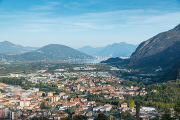 Fototapeta na wymiar City of Gravellona Toce, Italy, seen from above with Lake Maggiore in the background. Province of Verbano Cusio Ossola in Piedmont region