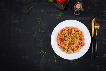 Tomato rice with vegetables and chicken. Healthy food. Healthy lifestyle. Top view, overhead