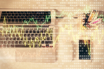 Multi exposure of forex graph drawing over desktop background with computer. Concept of financial analysis. Top view.