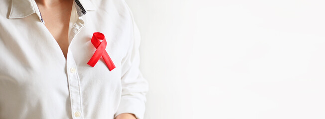 World AIDS and hiv day. Woman in white shirt holds red ribbon. Blood transfusion and donation. Hemophilia day. World Cancer Day - obrazy, fototapety, plakaty