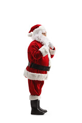 Full length profile shot of Santa Claus holding his beard