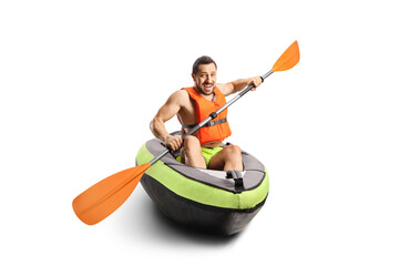 Smiling young man riding a canoe with a life vest