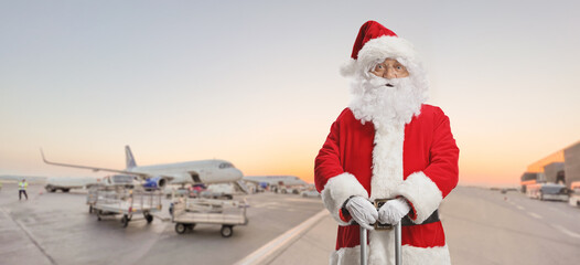 Santa claus standing with a suitcase standing on an airport