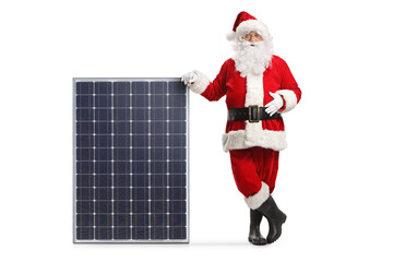Santa claus leaning on a big solar panel