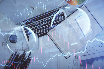 Multi exposure of forex chart drawing over table background with computer. Concept of financial...
