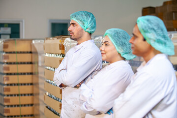 worker team on the production line in the beverage factory. Manufacturer checks quality of food industry. - 540637083