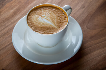 Cup of cappuccino on wooden table,top view