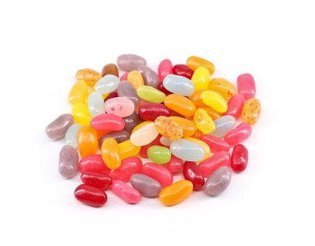Heap of colorful jelly bean candies on white background.