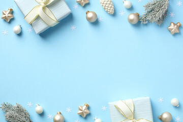 Blue Christmas background with gift boxes, baubles, fir branches.