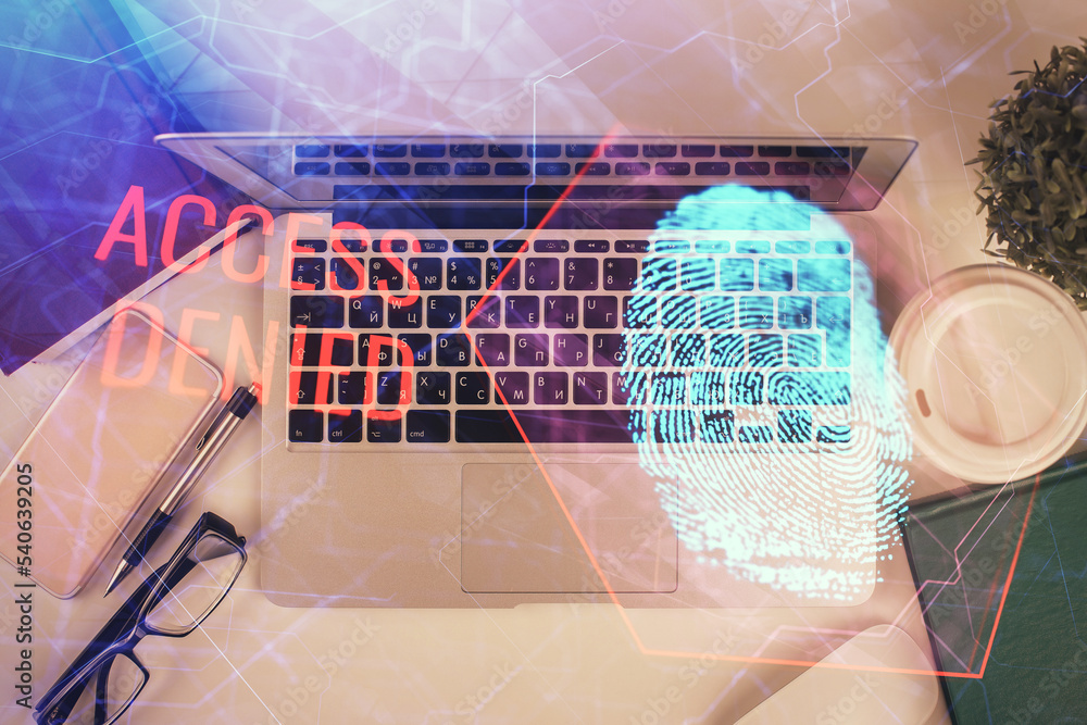 Poster Finger print over computer on the desktop background. Top view. Double exposure. Concept of securitization.