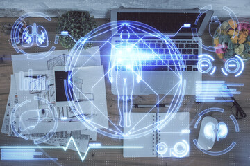 Education hologram drawings over computer on the desktop background. Top view. Multi exposure.