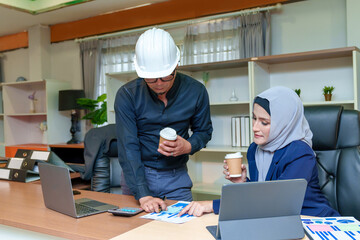 Intelligent office workers collaborating on new startup project using application for web design on modern laptop computers, male boss explain to woman details of next task on netbook indoors