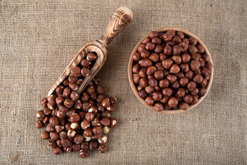 View of a bowl full of hazelnuts on burlap sack
