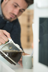 close-up of men pouring coffee