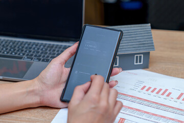 A businesswoman is transferring money using a financial app in her office.