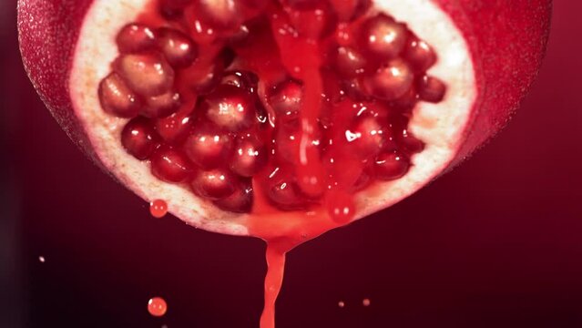 Slow Motion of Flowing Pomegranate Juice from Half Pomegranate