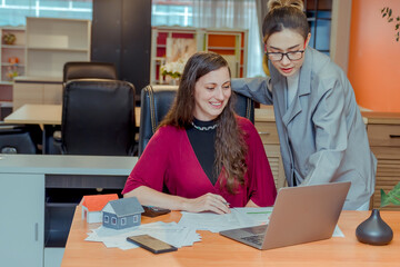 Finance,accounting,Businesswomen analyzing investment charts with calculator laptop calculate technology in office, marketing business analysis data concept