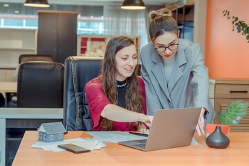 Finance,accounting,Businesswomen analyzing investment charts with calculator laptop calculate technology in office, marketing business analysis data concept