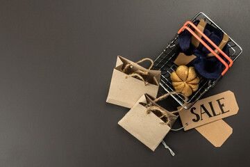 Black Friday Sale concept. Shopping basket, handmade tags, paper bags, and pumpkin cookies