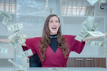 image of happy woman exults pumping fist happiness celebrating success under rain money falling dollar banknote isolated on gray wall background with copy space
