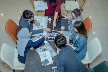 Startup business people group meeting. People group sitting on conference together and making notes. hands pointing at business document during discussion at meeting