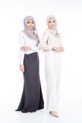 Portrait of two Muslim woman in office attire and wearing a hijab. Asian woman in a corporate world. Formal and elegant corporate outfit. Corporate or business people concept. Isolated