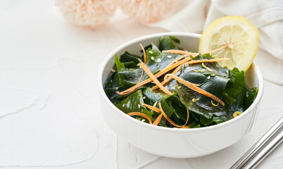 close up salad laminaria Kelp or wakame seaweed salad in bowl on white table background with copy space. salad laminaria Kelp or wakame seaweed salad food                          © boommaval