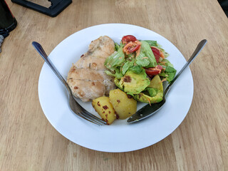 homemade chicken with potatoes and salad, healthy food