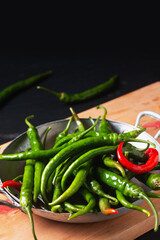 Organic food concept organic green cayenne peppers on black backrground with copy space