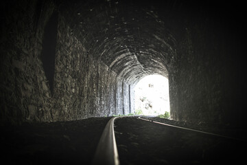 Old train tracks in a tunnel	