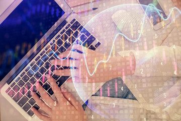 Double exposure of woman hands working on computer and forex chart hologram drawing. Top View. Financial analysis concept.