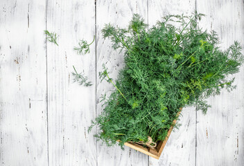 Fresh dill close up on wooden box on light background, preparation for freezing serving size organic healthy ething natural product portion. place for text