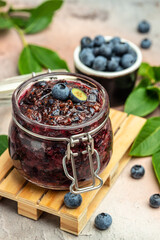 Blueberry jam or marmelade in glass. Blueberries fruits. vertical image. top view. place for text