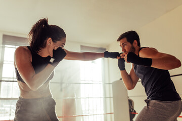 Young boxers fighting inside a boxing ring