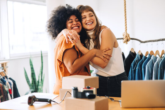 Happy Thrift Store Owners Embracing Each Other In Their Shop