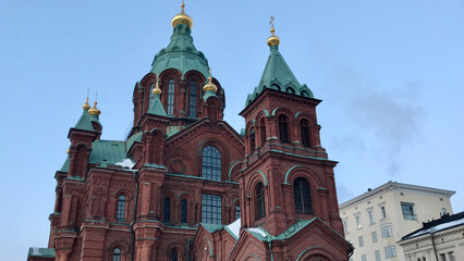 Fototapeta na wymiar Helsinki, Finland, February 2018 - A church with a clock on the front of a building