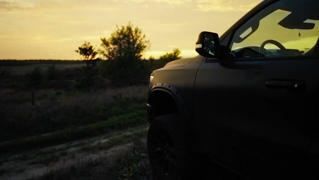Pickup Off Road Truck Silhouetted Static at Sunset - Revealing shot. Adventure and Travel Concept