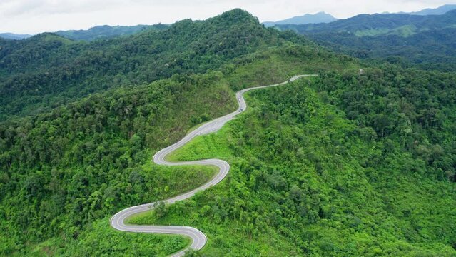 Aerial View Drone Fly Over Of Winding Road In Rainy Season On Tropical Rainforest Mountain In Nan Province, Thailand. Footage B Roll, Aerial Footage Of Winding And Dangerous Road.