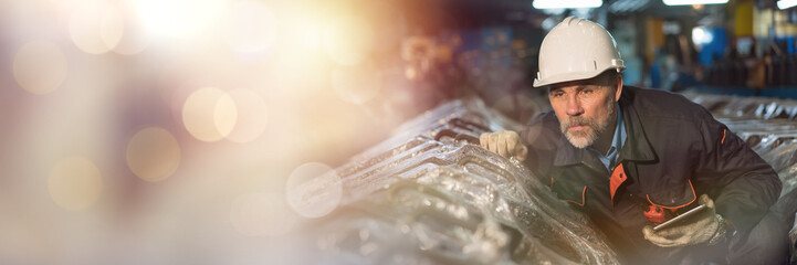 Senior male engineer maintaining machinery, mechanical machine at the industry factory. Male...