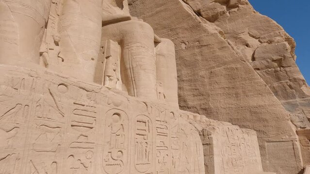 Close up of hieroglyphs and Ramses statue at Abu Simbel temples, Egypt
