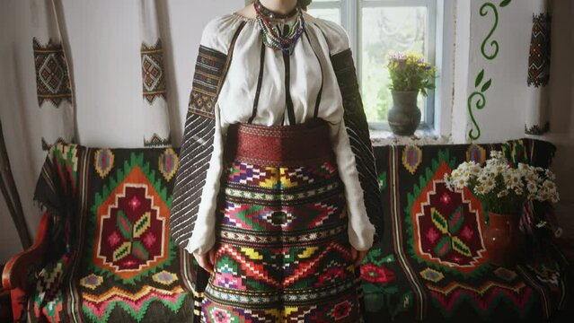 Young woman poses in national Ukrainian embroidered clothes