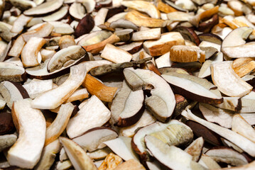 Background of sliced and raw edible mushrooms, lying on baking paper.