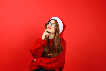 A young cheerful woman is thinking about a Christmas present, New Year's fuss.